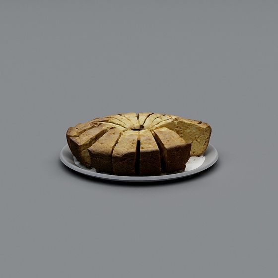 Sliced golden brown ring cake on a white plate on grey background