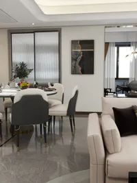 Close up of dining area featuring white table black chairs wall art and beige sofa