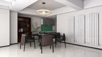 Modern dining room with round table, dark chairs, white wall radiators, and hanging ceiling light