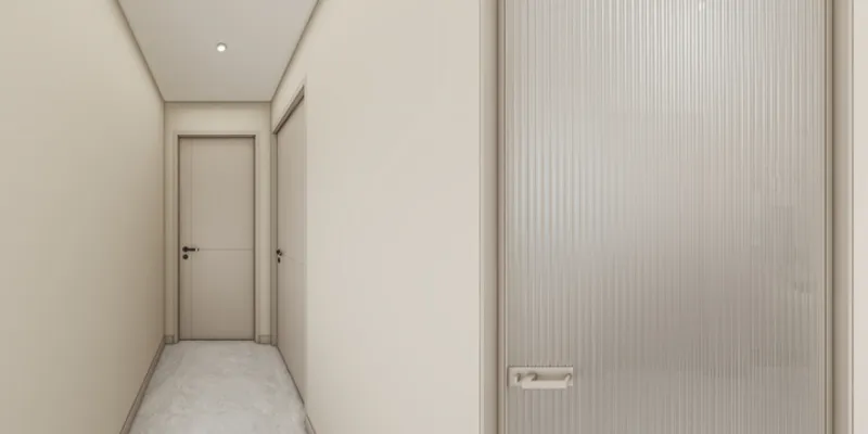 Modern minimalist hallway with cream walls marble floor two doors and a textured glass door