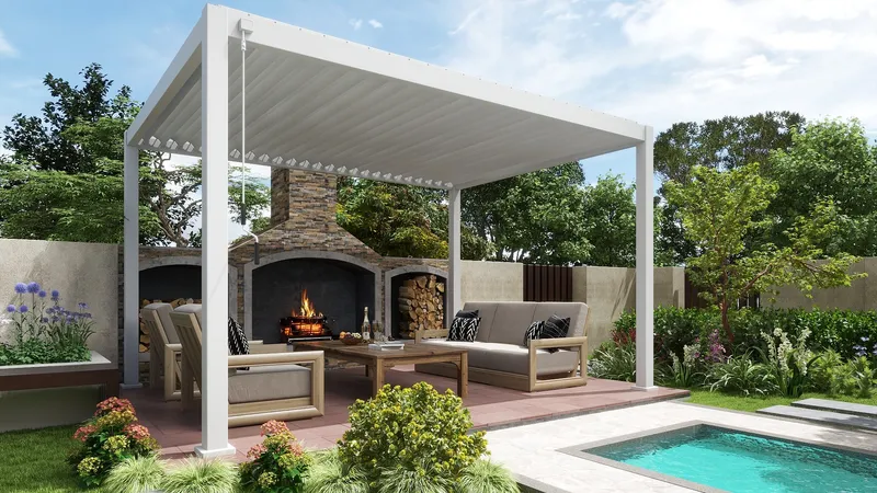 Modern outdoor patio with white shelter, grey sofa, wood table, stone fireplace, and swimming pool