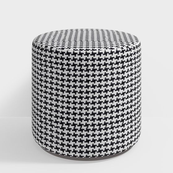 Round black and white patterned fabric footrest with soft cushion on light grey background