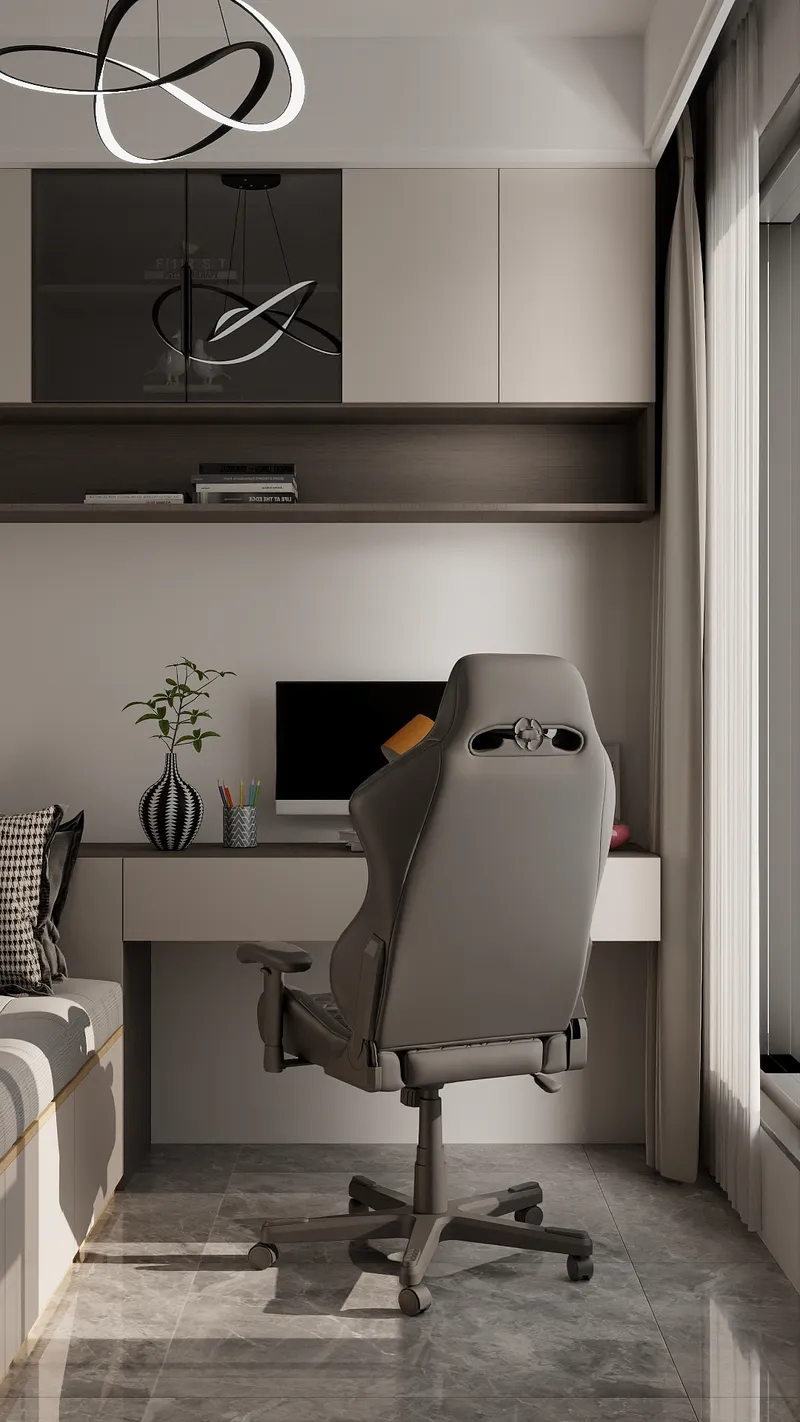Modern home office featuring grey gaming chair, sleek desk, computer, wall shelves, and ceiling light