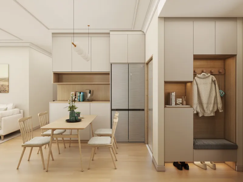 Modern dining room featuring wooden table four chairs silver fridge white cabinet and coat storage