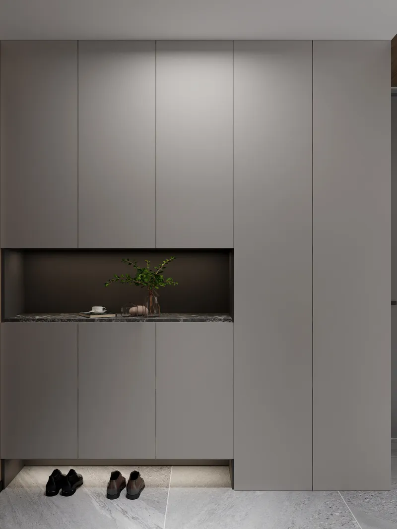 Modern grey cabinet with green plant on marble shelf and leather shoes on tiled floor