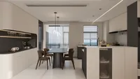 Modern open plan kitchen and dining room with black table, brown chairs, and white cabinets