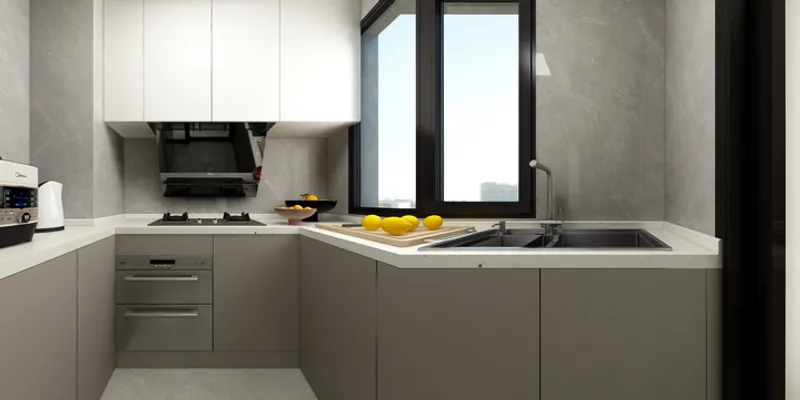 Modern kitchen with grey cabinets white wall units stove sink black window and fresh lemons