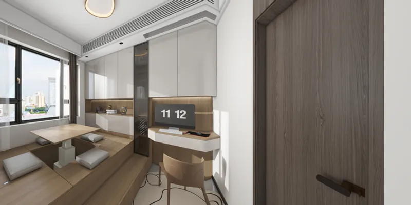 Room with raised wood floor, lifting table, white desk, computer, wall cabinets and brown door
