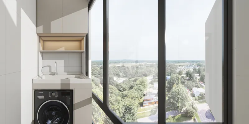 Bright laundry balcony including black washing machine white sink overhead cabinets and large glass windows