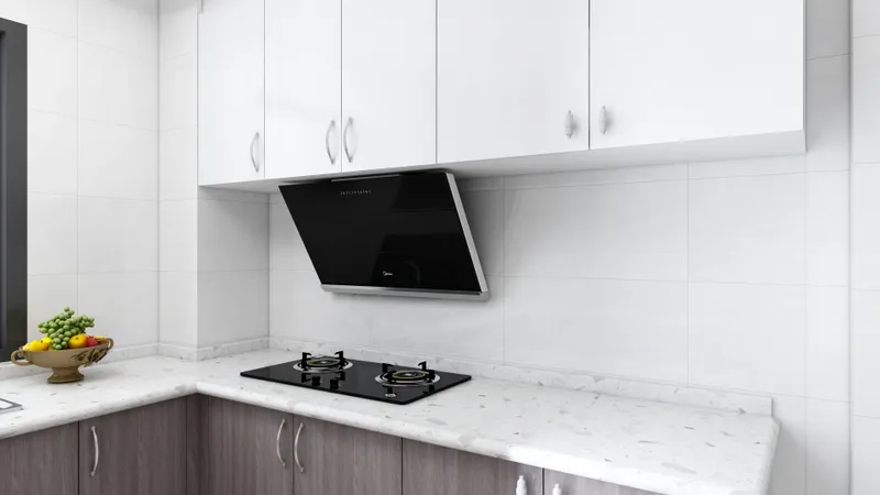 White wall cabinets above dark wood base units with marble countertop and black gas stove