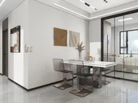 Modern dining area with white table, clear chairs, marble floor, wall art, and kitchen view
