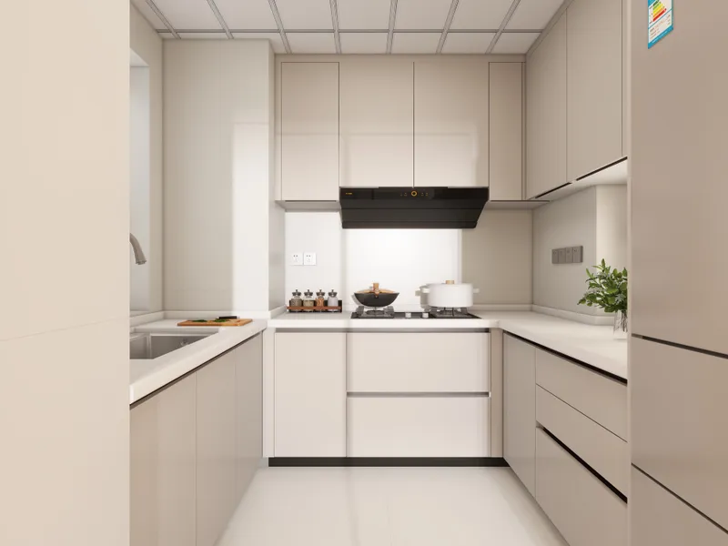 Modern kitchen with beige cabinets white countertop stove with pot sink and small green plant