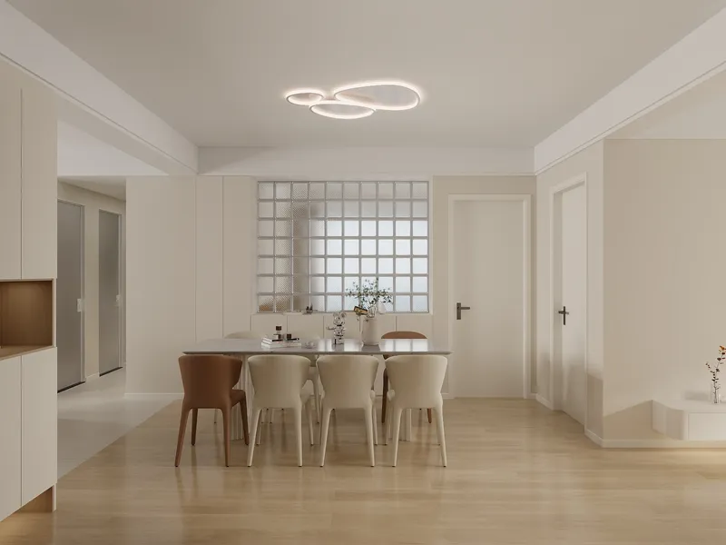 Modern dining room with beige chairs, marble table, glass block wall and white ceiling light