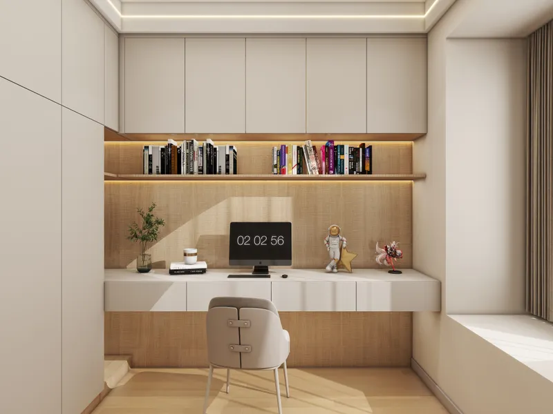 Modern home office with white floating desk, cream chair, computer monitor, bookshelves, and wall cabinets