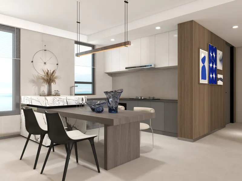 Modern kitchen with wooden dining table and black chairs beside a white marble island counter