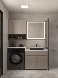 Grey bathroom with washing machine under counter beside black sink and lighted square wall mirror