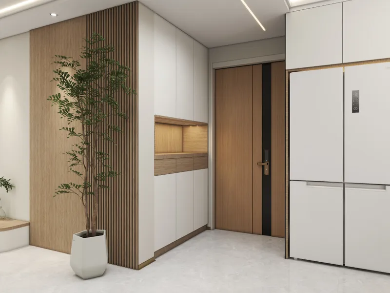 Modern home entrance with wooden wall panels, green plant, white cabinet, brown door and refrigerator