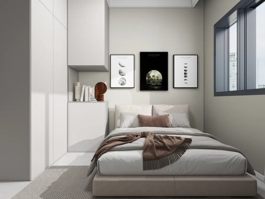 Modern bedroom with grey bed brown blanket three framed moon pictures and white storage cabinets