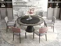 Circular rug under a round dining table surrounded by six grey and pink modern chairs
