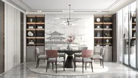 Modern dining room with round black table, pink chairs, ceiling light, and a wall painting