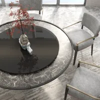 Round marble dining table with grey chairs and a small plant in a modern room