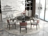 Round marble dining table with pink and grey chairs, ceiling light, and a landscape mural