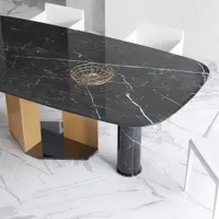 Top view of black marble table surface with gold wire basket on white marble floor