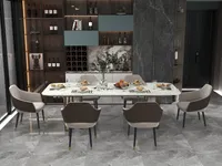 Dining area with set table, brown chairs, grey marble floor, wine cabinet, and green plant