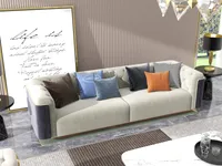 Beige sofa with colorful pillows next to large wall art and black side table lamp