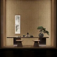 Zen tea room with wooden wall, long wood table, two stools, bonsai tree, and scroll