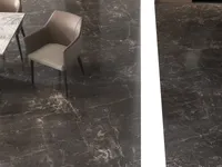 Side view of brown chair and white table on dark marble floor with white stripe