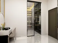 Modern dressing room with white desk beige chair round mirror glass door and walk-in closet