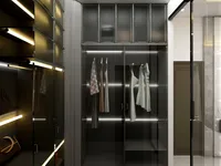 Modern walk in closet with glass doors, internal LED lighting, hanging clothes, and designer handbags.