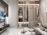 Modern bedroom featuring glass door closet with lights grey bedding wall mounted TV white floor