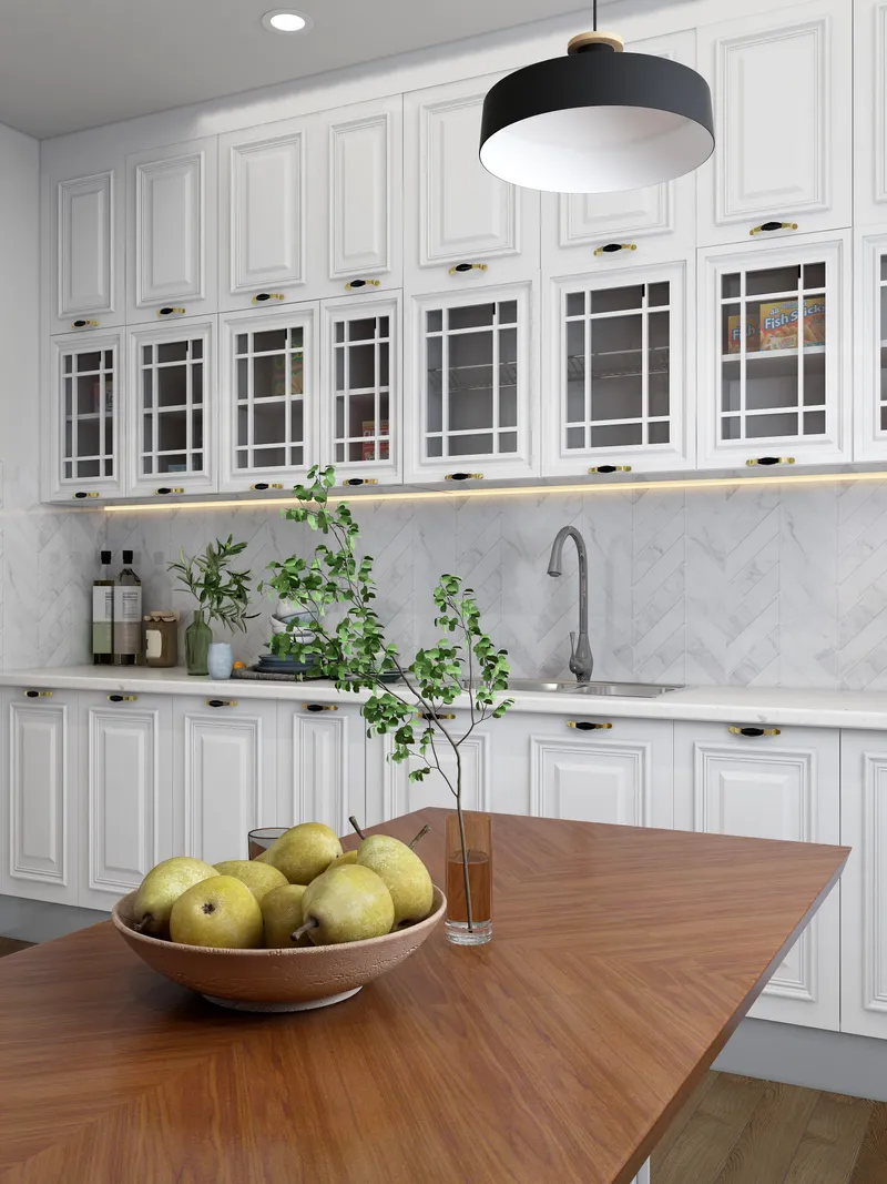 White kitchen featuring bowl of pears on wooden table marble backsplash and a ceiling light