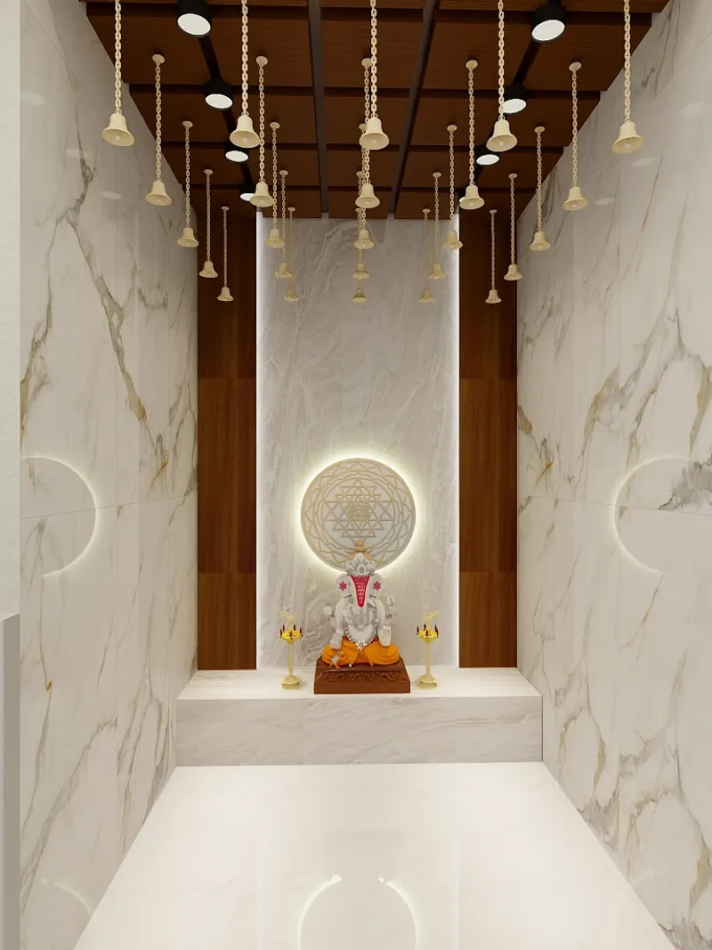 Modern prayer room featuring marble walls hanging gold bells and a statue with warm lighting