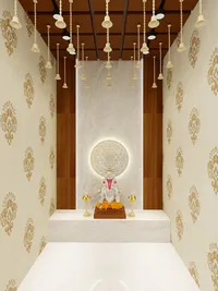 Elegant prayer space with patterned wallpaper hanging gold bells and a statue with warm lighting