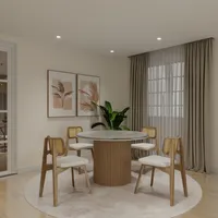 Round marble dining table with fluted base, four chairs, wall art, plant, and round rug