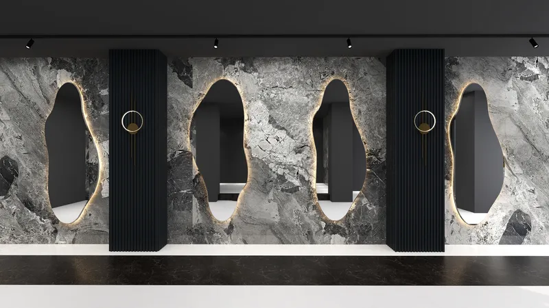 Grey marble wall with black wall panel backlit mirrors and golden round wall light fixtures