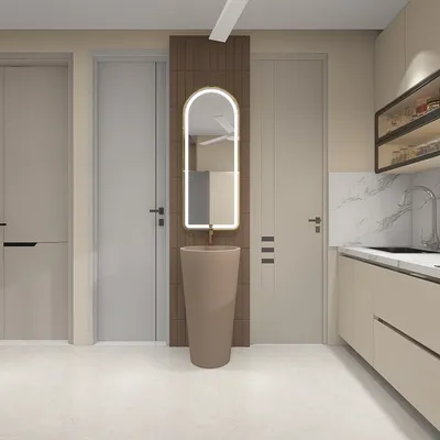 Modern hallway with beige sink, arched mirror, brown wall panel, kitchen cabinets, and grey doors