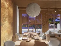Dining table with round ceiling light, white chairs, wooden blinds, and sofa in the background