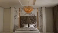 Elegant master bedroom with brown leather headboard marble wall panels and gold tiered ceiling light