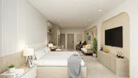 Large modern bedroom with wooden bed, white bedding, television, sofa, and a luxury massage chair