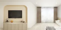 Flat screen television mounted inside a beige wall arch above a light wood storage cabinet