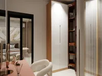 Modern dressing area with pink table, white chair, wooden wardrobe, curved shelves, and large mirror