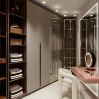 Walk in closet area with grey cabinets pink dressing table lighted mirror and white chair