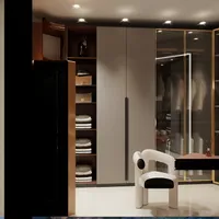 Modern walk in closet with grey wardrobe, glass doors, white designer chair and bright lights