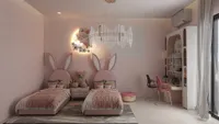 Pink kids bedroom with two bunny beds decorative wall light study desk and ceiling light