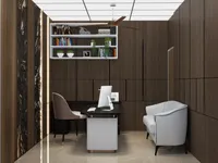 Office room featuring dark wood wall panels desk computer white chair sofa and wall bookshelf