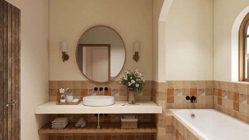Warm bathroom interior with round mirror white sink brown wall tiles bathtub and wall light